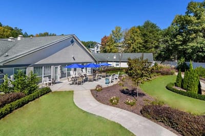 Outdoor patio area with seating and gardens