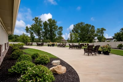 Outdoor patio area with seating and greenery