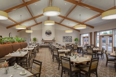 Bright dining room with tables set for meals