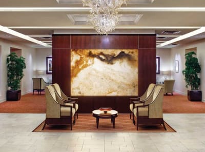 Elegant lobby interior with seating and decorative wall