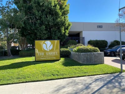 The Variel facility sign with greenery