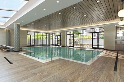 Indoor pool area with natural light and wood accents