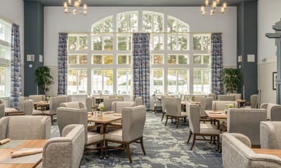 Bright dining room with large windows and elegant decor