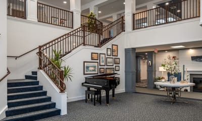 Interior view of a staircase area with a piano