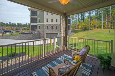 Screened porch with chairs overlooking landscaped grounds