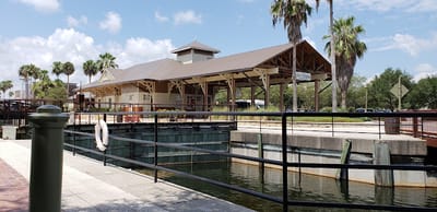 Exterior view of a facility near water with palm trees