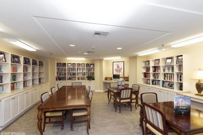 Interior view of a library with bookshelves and tables