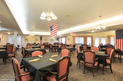 Dining area with tables and chairs set for meals