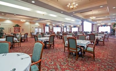 Dining area with tables and chairs arranged for residents