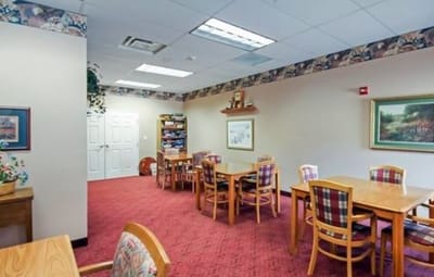 Interior view of a cozy common area with tables and chairs