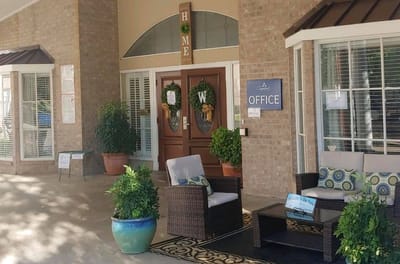 Front entrance of The Waterford at Mesquite with outdoor seating
