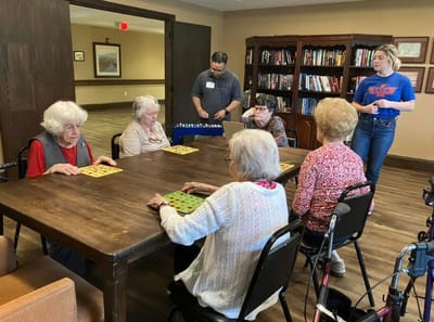 Residents playing bingo in an activity room