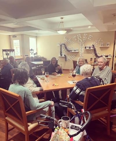 Residents engaged in a group activity at a communal table