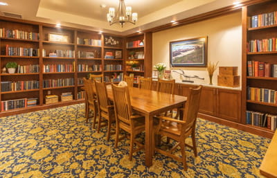 Interior common area with bookshelf and dining table