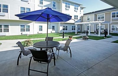 Outdoor patio area with seating and umbrella