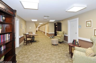 Interior view of a hallway with seating and bookshelves