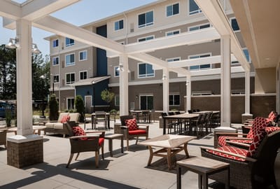 Outdoor seating area with modern furniture at a senior living facility