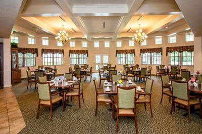 Bright dining area with tables and chairs set up