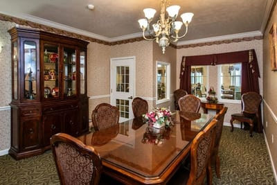 A dining room setup with a large table and decorative elements