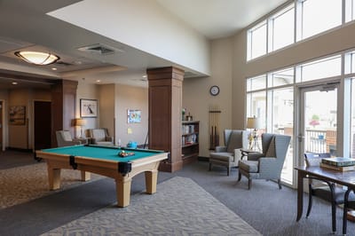 Bright common area with pool table and seating