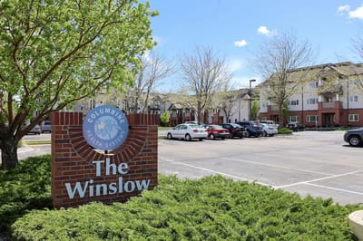 Exterior view of The Winslow with parking lot and landscaping