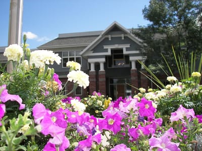 Vibrant flowers in front of a senior living facility