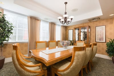 Bright dining room with large wooden table and chairs
