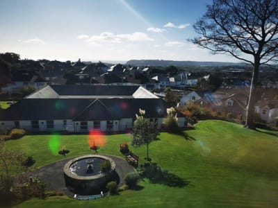 Aerial view of the facility surrounded by landscaped gardens