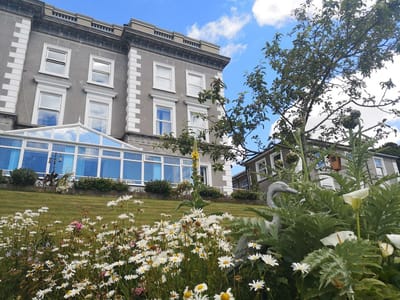 Exterior view of the facility with flowers in foreground