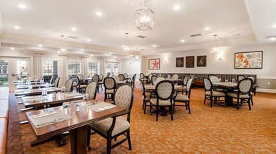 Dining area with tables and chairs, well-lit