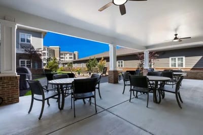 Covered outdoor seating area with tables and chairs