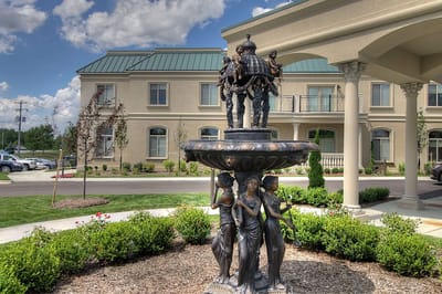 A decorative fountain in front of the facility