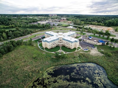 Aerial view of Tranquility Senior Living facility surrounded by greenery