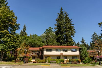 Exterior view of the assisted living facility surrounded by trees