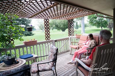 Residents relaxing on a covered deck area