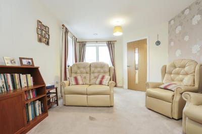 Bright and cozy common area with seating and bookshelves