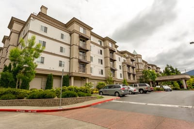 Exterior view of University House Issaquah with landscaped entrance