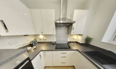 Modern kitchen interior with white cabinets and appliances