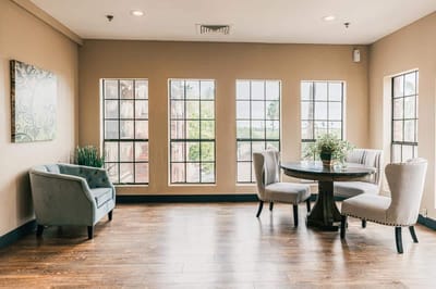 Bright common area with seating and large windows