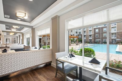 Bright common area with pool view and dining setup