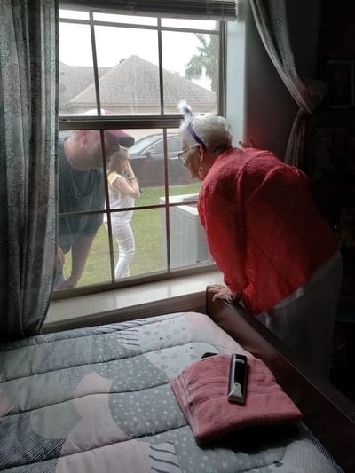 Residents looking out the window of their room
