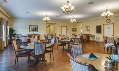 Bright dining room with tables and chairs set for meals