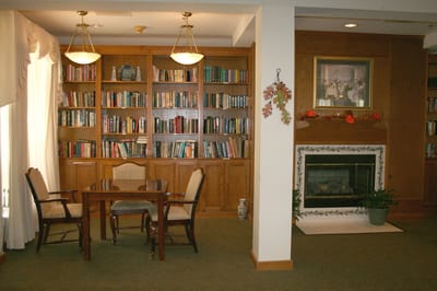 Cozy library area with bookshelves and seating