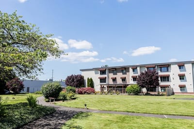 Exterior view of a senior living facility with landscaping
