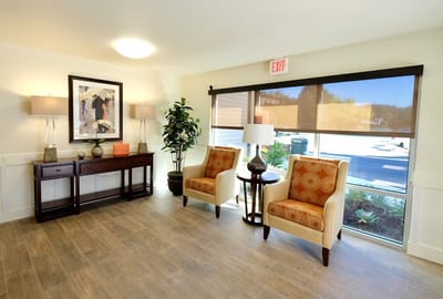Welcoming interior lounge area with chairs and lamps
