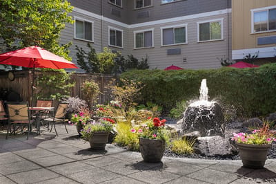 Outdoor seating area with a fountain and flowers