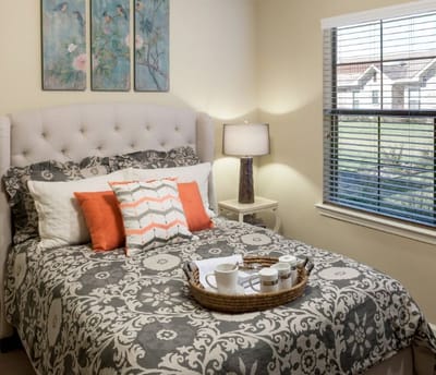 Cozy resident room with a bed and decorative pillows