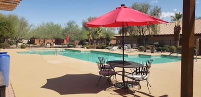 A serene outdoor pool area with umbrellas and seating