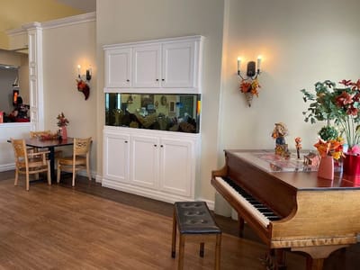 Interior view of a common area with piano and decorations