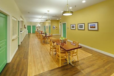 Dining area with wooden tables and green doors
